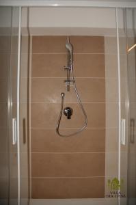 a shower with a shower head in a bathroom at Villa Tra i Pini - Green & Relax in Castellana Grotte +34 photos