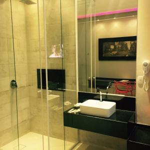 Dinys Motel (Adults Only) في برايا جراندي: حمام مع حوض ودش زجاجي