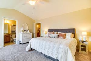 a bedroom with a large bed and a bathroom at Half-Mi to Grand Lake Townhome with Hot Tub in Afton +30 photos
