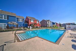a swimming pool in a residential neighborhood with houses at Half-Mi to Grand Lake Townhome with Hot Tub in Afton