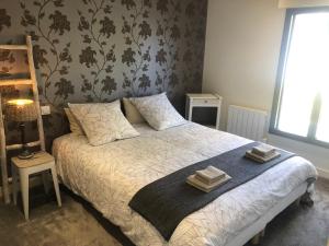 ein Schlafzimmer mit einem Bett mit zwei Handtüchern darauf in der Unterkunft Ty Bihan - Cœur de bourg in Saint-Gildas-de-Rhuys