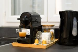 a coffee maker sitting on a kitchen counter with a drink at Le Michigan Studio Near Paris in Aubervilliers