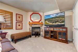 a living room with a tv and a fireplace at Bear Hollow Village 5437 by Moose Management in Park City