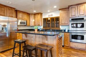 a kitchen with wooden cabinets and stainless steel appliances at Bear Hollow Village 5437 by Moose Management in Park City