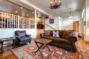 a living room with a couch and a chair at Bear Hollow Village 5437 by Moose Management in Park City +71 photos