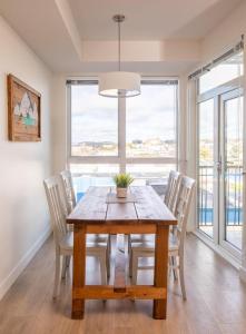 a dining room with a wooden table and chairs at Urban Stay With Balcony And In-Unit Laundry in Victoria +11 photos