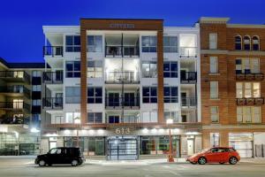 two cars parked in a parking lot in front of a building at Urban Stay With Balcony And In-Unit Laundry in Victoria