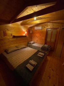 a bedroom with two beds in a log cabin at Amazonas Beach in Ulcinj