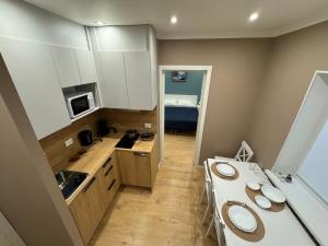 a small kitchen with two sinks and a counter at Apartment by the bar in Imatra