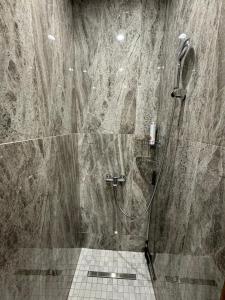 a bathroom with a shower with a toilet in it at Apartment by the bar in Imatra +51 photos