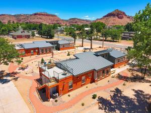 an overhead view of a building with mountains in the background at Timber & Tin D 2Bed 2Bath w Pool & Rooftop Deck in Kanab