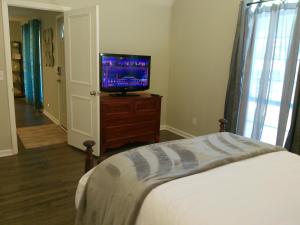 a bedroom with a bed and a television on a dresser at Trail Hollow in Sanford