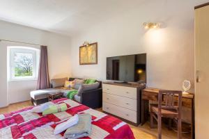 a bedroom with a bed and a living room at House Gioia Cristina in Labin