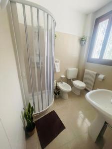 a bathroom with a shower and a toilet and a sink at Casa9cento in Omegna