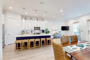 a kitchen and dining room with a table and chairs at Fairway Sunsets in Port Aransas