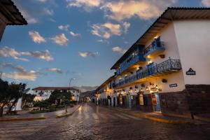 an empty street in a town at night at Hotel Hacienda Cusco Plaza in Cusco