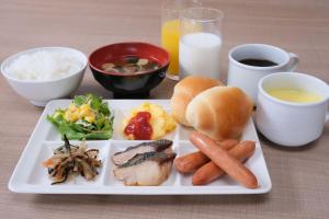 a plate of food with meat and vegetables and rice at Ace Inn Matsumoto in Matsumoto