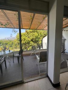 a view from the balcony of a house with sliding glass doors at Apartamento 2 habitaciones aire acondicionado en Sopetran Unidad res Piscinas sol y descanso in Sopetran