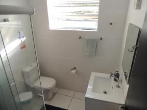 a small bathroom with a toilet and a sink at room itaim in Sao Paulo