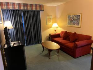 a living room with a red couch and a table at Hardman House in Carson City