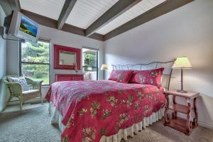 a bedroom with a large bed with a red comforter at Lakeland Village 610 Lakefront Beauty On Water in South Lake Tahoe +34 photos