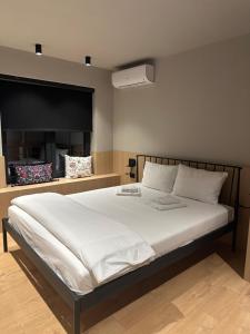 a bedroom with a large white bed with a fireplace at Villa Number 6 in Skopje