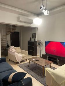 a living room with a large flat screen tv at Neama town in Sharm El Sheikh