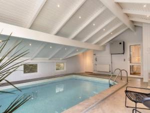 a swimming pool in a house with a ceiling at 10 person holiday home in L kken in Løkken