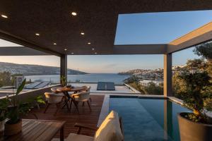 a house with a pool and a view of the ocean at Marje Villas Bodrum in Bodrum City