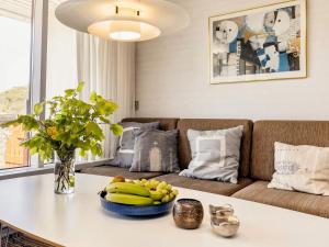 a living room with a couch and a table with bananas at 6 person holiday home in Pandrup in Rødhus