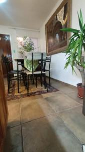 a dining room with a table and chairs and a plant at Cabañas Toto Península Beach in Totoralillo