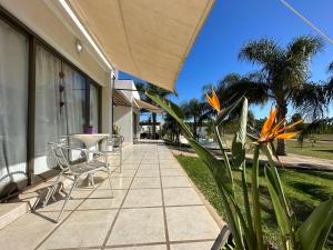a patio with chairs and plants on a house at Chajari Suites in Chajarí