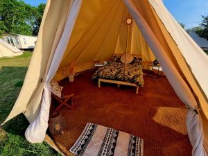a bedroom in a tent with a bed in it at Japanese tent Secret garden glamping in Newark upon Trent