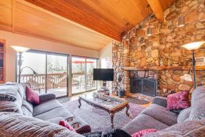 a living room with a couch and a fireplace at 1 Mi to Lake Tahoe Home with Hot Tub and Decks in Tahoe City