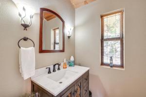 a bathroom with a sink and a mirror at 1 Mi to Lake Tahoe Home with Hot Tub and Decks in Tahoe City +21 photos