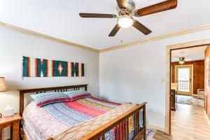 a bedroom with a bed and a ceiling fan at Rustic Angel Fire Condo Resort Shuttle On-Site! in Angel Fire