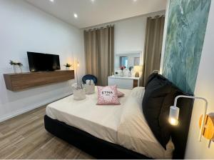 a bedroom with a bed with a pillow on it at Casa Belfiore Etna-apartments in Giarre