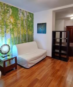 a living room with a white couch and a large window at B&B AeR in Lesina