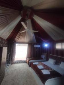 a bedroom with two beds in a tent at Waid Rum Jordan Jordan in Wadi Rum