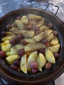 a pan with potatoes and grapes in a pan at Dar Imoughlad in Marrakech