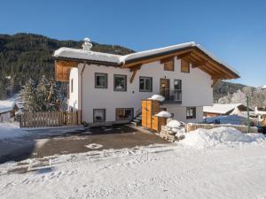 a house in the winter with snow on the ground at Roßbrand-Blick in Untertauern