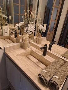 a woman taking a picture of a bathroom counter with three sinks at CASA ADAGIO in Ciudad Lujan de Cuyo