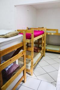 a group of bunk beds in a room at Canoa Roots Hostel & Camping in Canoa Quebrada