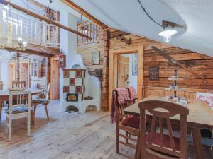 a dining room with a table and chairs in a cabin at Hauserbauer Small in Bramberg am Wildkogel