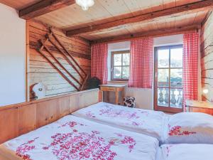 a bedroom with a bed in a room with wooden walls at Hauserbauer Small in Bramberg am Wildkogel