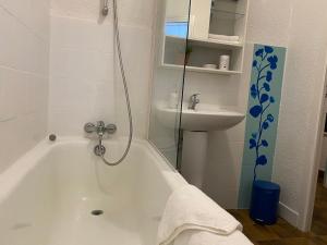 a white bathroom with a tub and a sink at Super Menton Bord Mer in Menton +33 photos