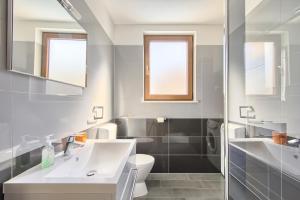 a bathroom with a white sink and a toilet at Apartments Spagnolo in Ližnjan