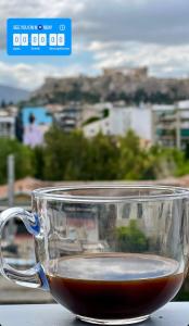 a glass cup of tea sitting on a table at Acropolis view Penthouse46 Jacuzzi Quality living in Athens +32 photos
