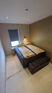 a bedroom with a large bed with a window at Black Beach Apartment - Vík in Vík