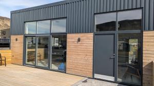 a building with glass windows and a door at Black Beach Apartment - Vík in Vík